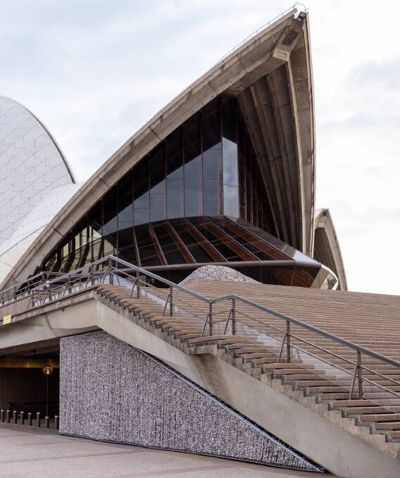 First Nations artist Megan Cope has created a windbreak below the exterior staircase of the Sydney Opera House to mark its 50th anniversary. The artwork evokes the ancestral midden sites that were used there for Aboriginal celebrations and gatherings for thousands of years. Picture by Daniel Boud
