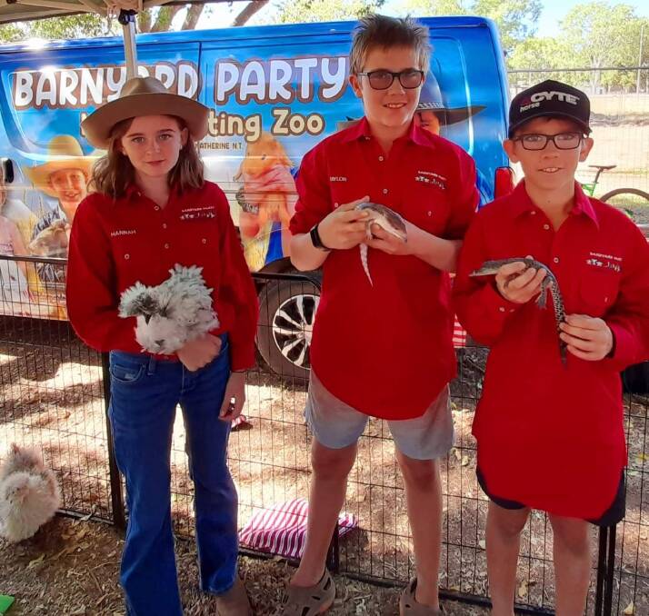 Mrs Shae's daughter Hannah, with Mitch and Taylor Bernard, who work at the Barnyard Mobile Petting Zoo. 