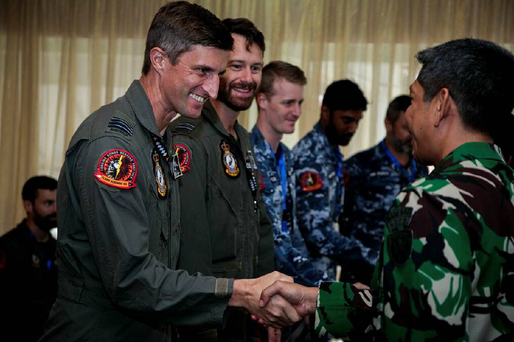 Commanding Officer No. 75 Squadron Wing Commander Martin Parker shakes hands with an Indonesian Air Force (TNI-AU) officer during the Exercise Elang AUSINDO 2023 opening ceremony at Sam Ratulangi Air Force Base, Manado.