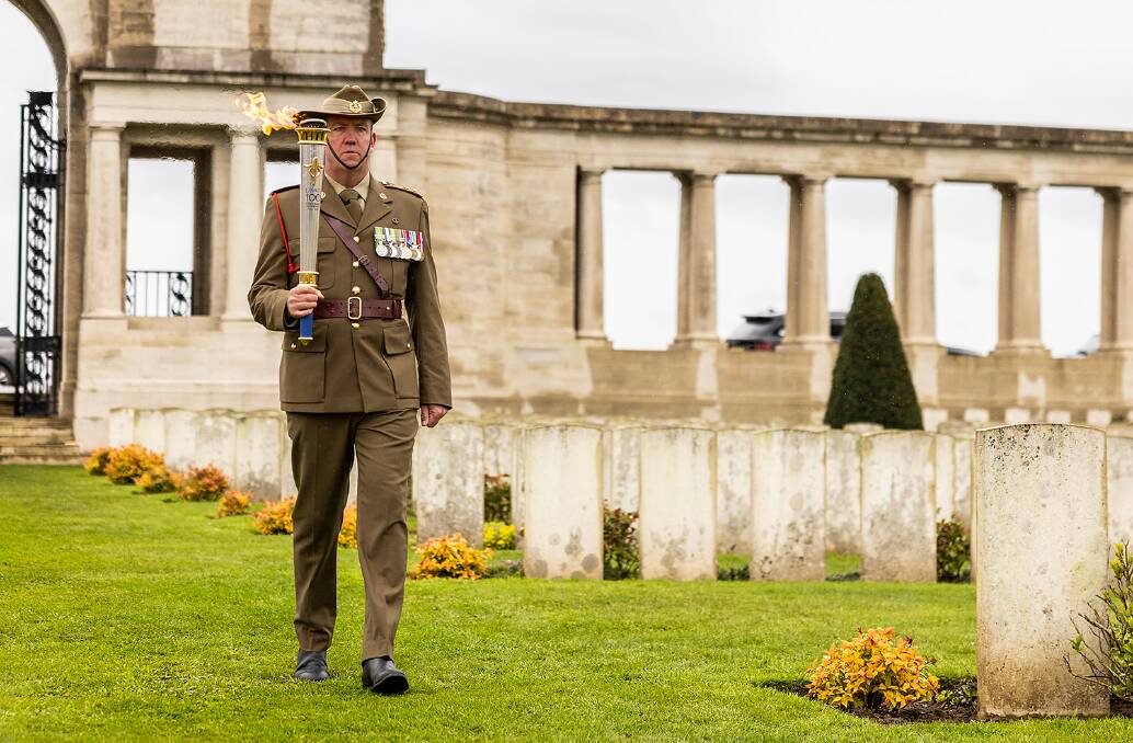 Lieutenant Colonel Anthony Birch, of London Legacy and Australian Army Liaison Officer British Army HQ carries the Legacy Centenary Torch into the Official Opening Ceremony at The Pozèries British Cemetery.