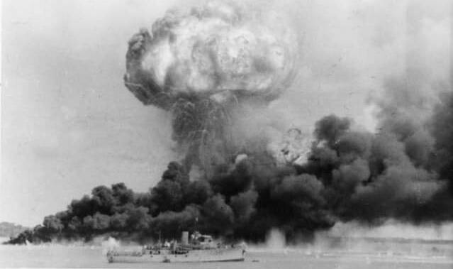 Dense clouds of smoke rise from oil tanks hit during the first Japanese air raid on Australia's mainland. Picture - RAN Historical Collection, 1942. 128108 Australian War Memorial.