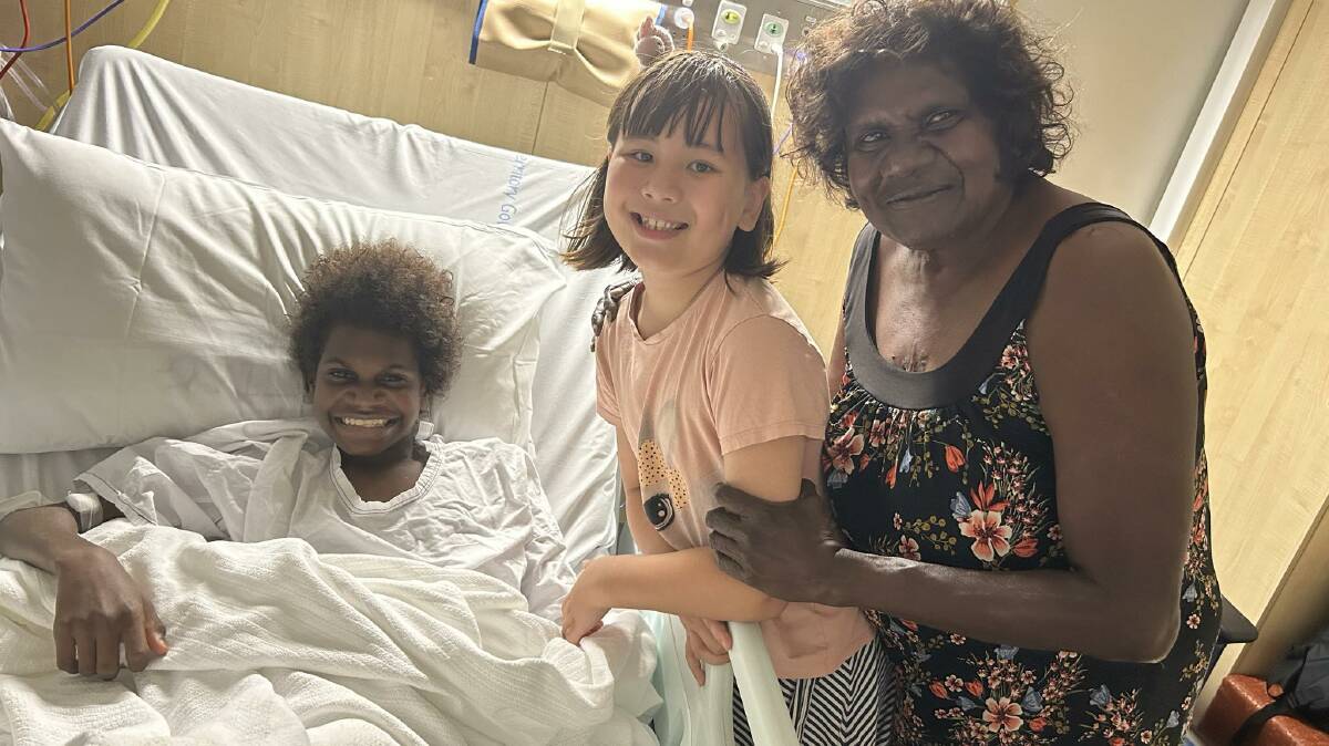 All smiles again - Tyrell Nundhirribala with family friend Emma Ryan and his grandmother Virginia Nundhirribala, in hospital in Darwin. 