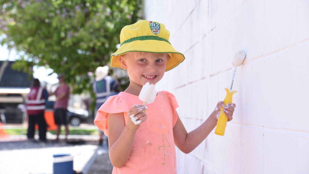 HARD AT WORK: Zoe Hard, 6, battling the heat with an icy-pole during her school holiday break. 