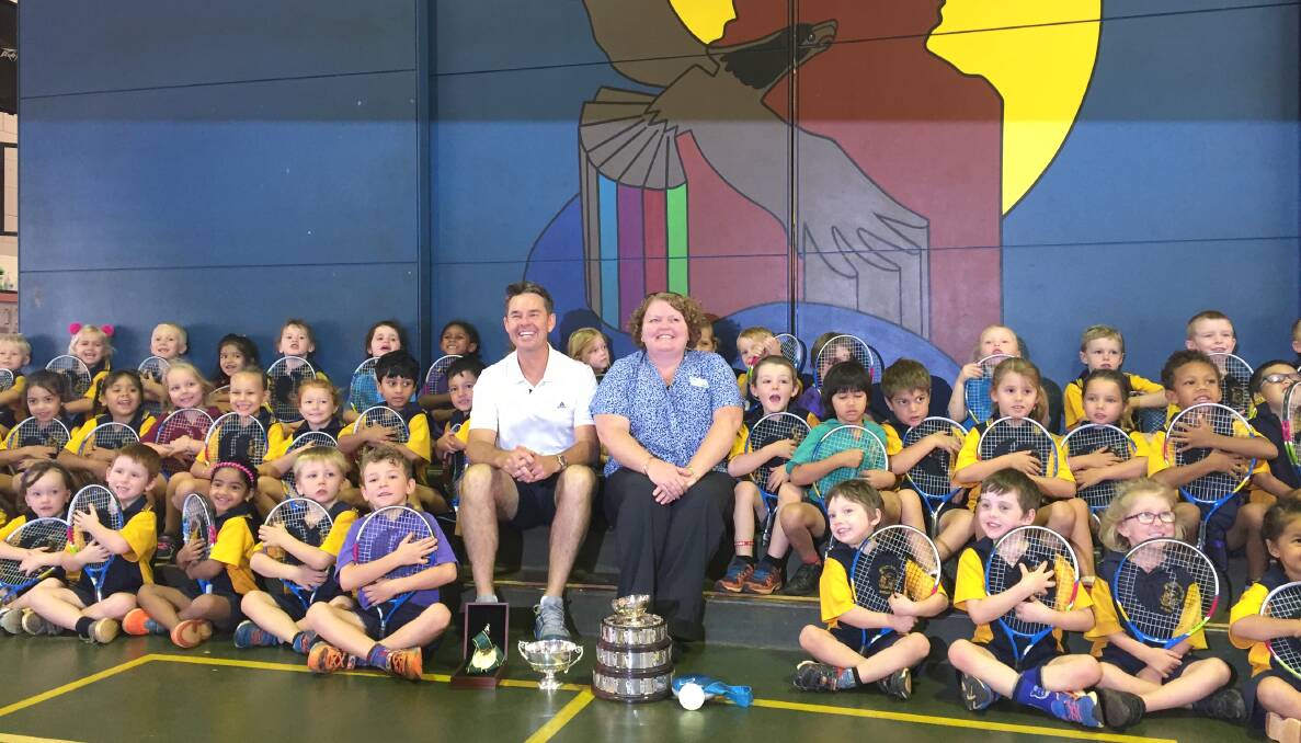 TENNIS CHAMP: Todd Woodbridge with ANZ personal banker Trish Aspey and Casuarina Street Primary School students.  