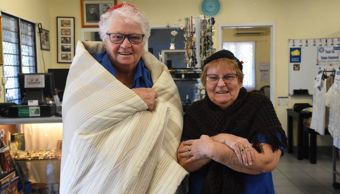 RUGGED UP: Vinnies volunteer Maureen O'Keeffe and coordinator Margaret Rogers, warm in their blankets on a chilly Katherine morning where the average minimum temperature for May is 17.5 degrees. 