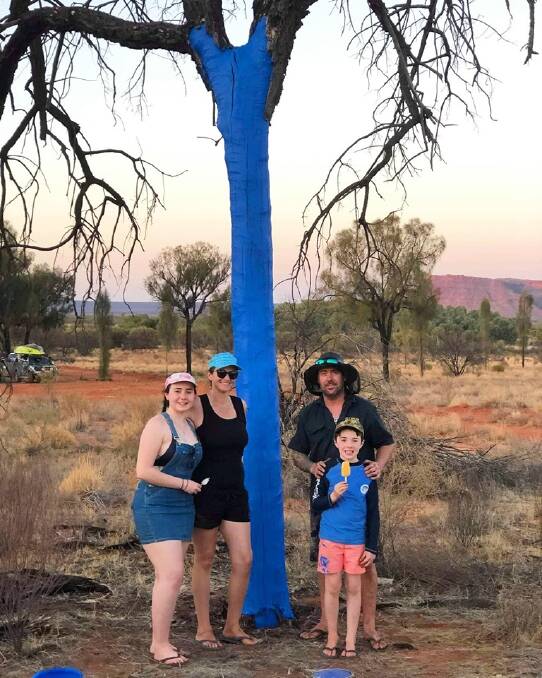 Tammie Burke and her family travelled from Perth and painted one of the first blue trees in the Northern Territory. Picture: Supplied. 