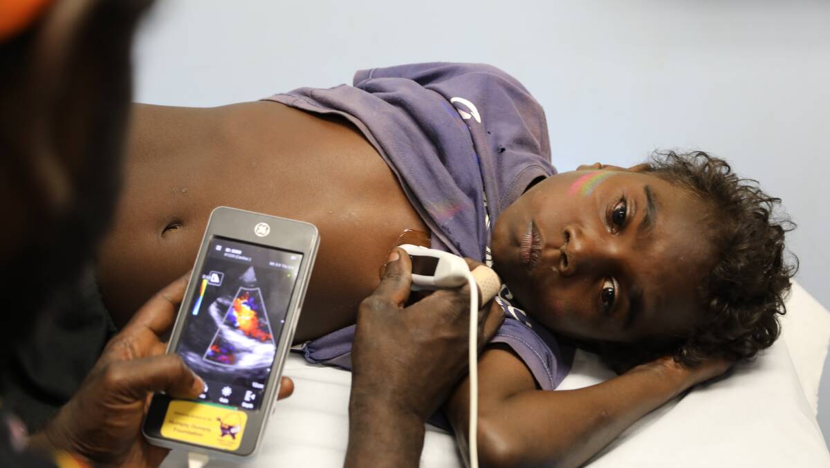 Rheumatic Heart Disease patient, Trey, receives a handheld echo scan in Manigrida. Picture: Supplied. 