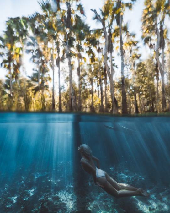 Social media influencer Carmen Huter's photo of the crystal clear waters of the popular NT swimming hole has shown off the Territorys natural assets to all corners of the globe. Picture: @carmenhuter