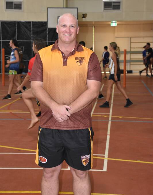 Coach John Parker, an avid AFL player can no longer play the game he loves due to a knee injury. 