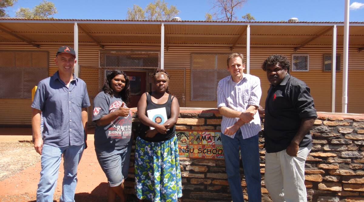 LANGUAGE STUDY: Dr John Guenther and co-author Dr Sam Osborne at Amata Anangu School with local staff. 