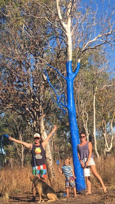 Liam, Amanda and Banjo painted a tree on the Stuart Highway blue to raise awareness about mental health in June - it was possibly the first in the Northern Territory. Picture: Supplied. 