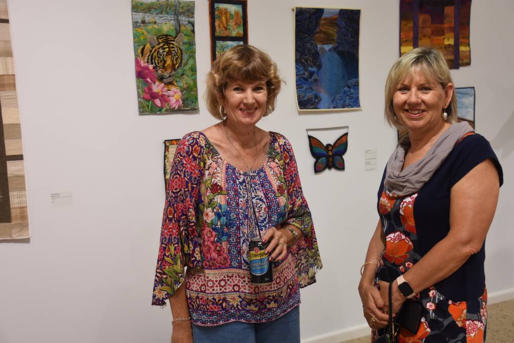 Leisa Conn and Jo Hersey take in the art. 
