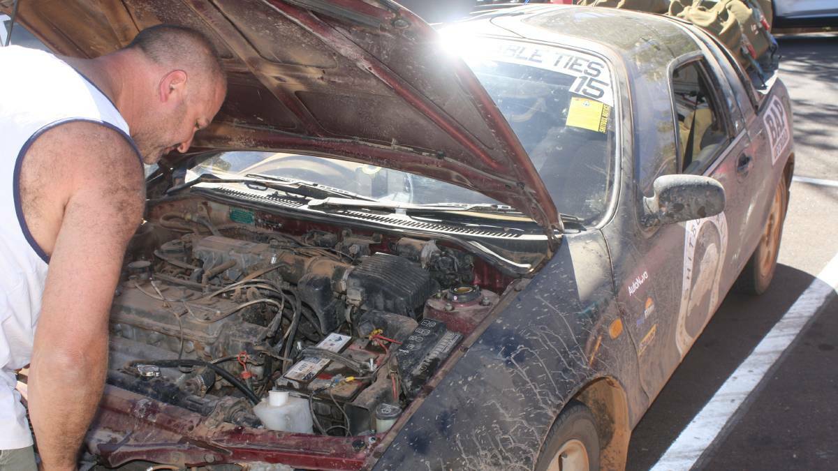 A participant checks his engine in Katherine in 2018, as the vehicles must be extremely cheap and valued under $1000.