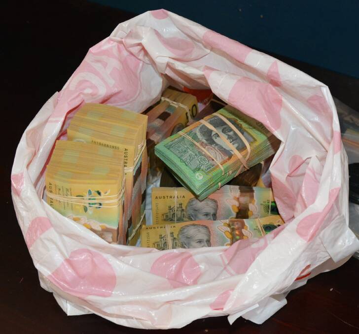 The Regional Investigation Division executed a search warrant on the man's home where they found a bag of cash. Picture: NTPFES Media. 