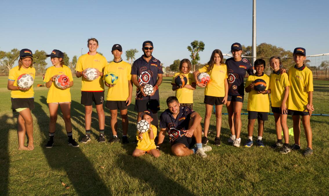 Tennant Creek coaches with a bunch of the youth taking part in the new John Moriarty Football program. Picture: Supplied. 