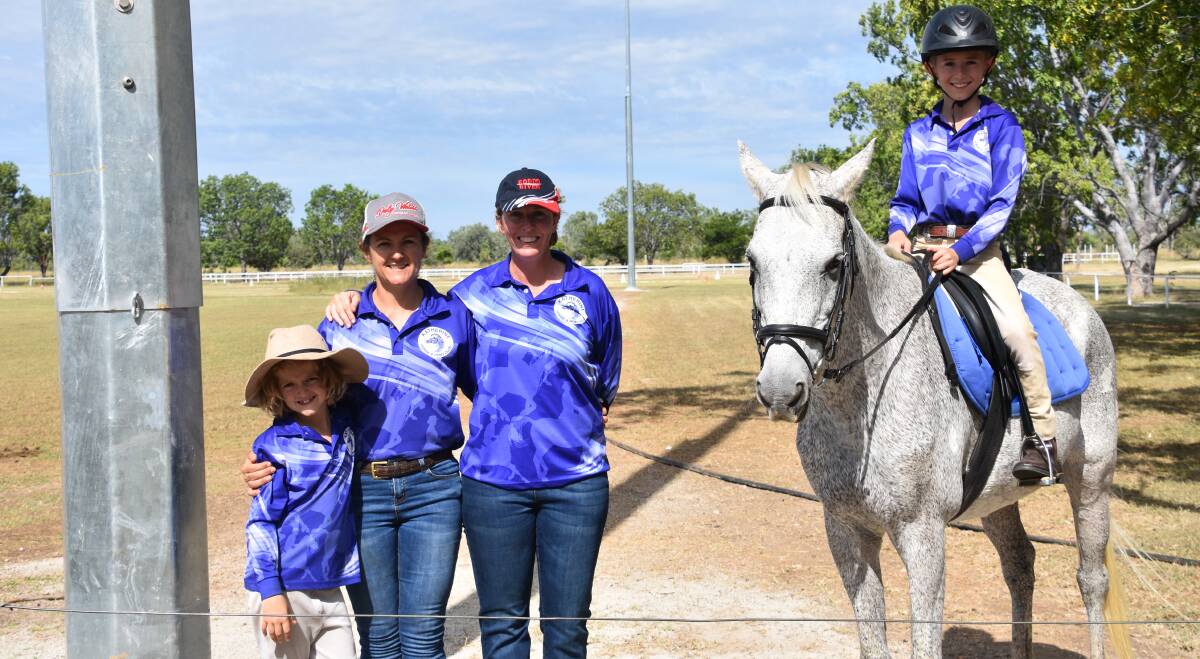 Standing proudly next to one of the large and tall lights is Caitlin Dennis, Katherine Horse and Pony Club vice president Alison Ross, Julie Branson, her son Harrison Branson and Native. 