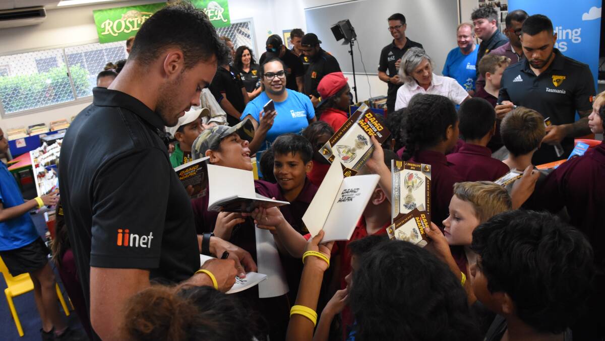 SPECIAL GUESTS: Hawthorn player Connor Nash signs books for excited Macfarlane Primary School Students at today's book launch. 