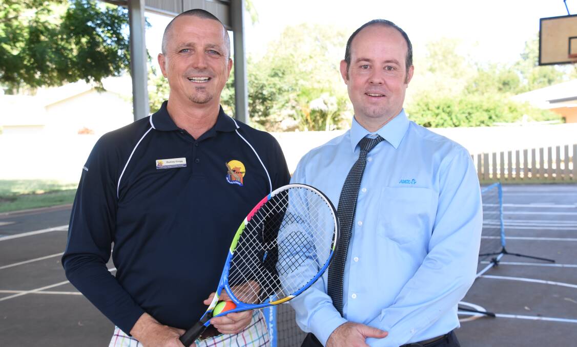 Physical education teacher Rodney Gregg was thrilled to recieve the new funding from Katherine ANZ branch manager Charles Hunter. 