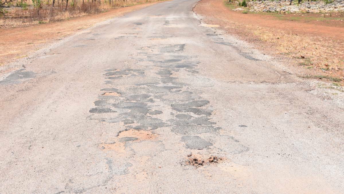 WORN OUT: Vehicles often have to navigate prolific potholes and off-road tracks in order to get home, making for longer and more dangerous trips. 