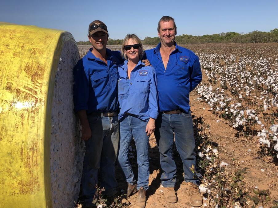Nick Black, Maya Black and Steve Black stand with one of the many bales of freshly picked cotton at their station about 50km outside of Katherine. Picture: Supplied. 