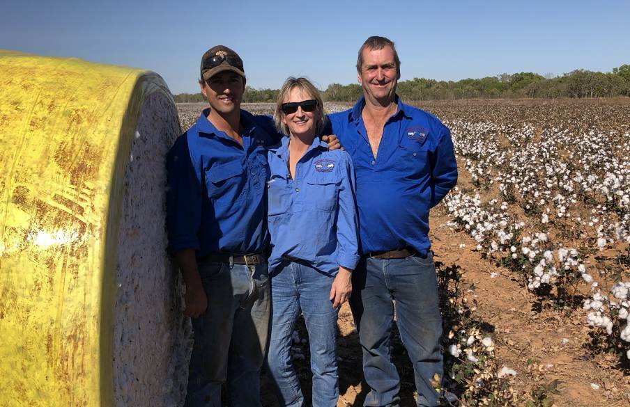 Nick Black, Maya Black and Steve Black stand with one of the many bales of freshly picked cotton at their station about 50km outside of Katherine. Picture: Supplied. 