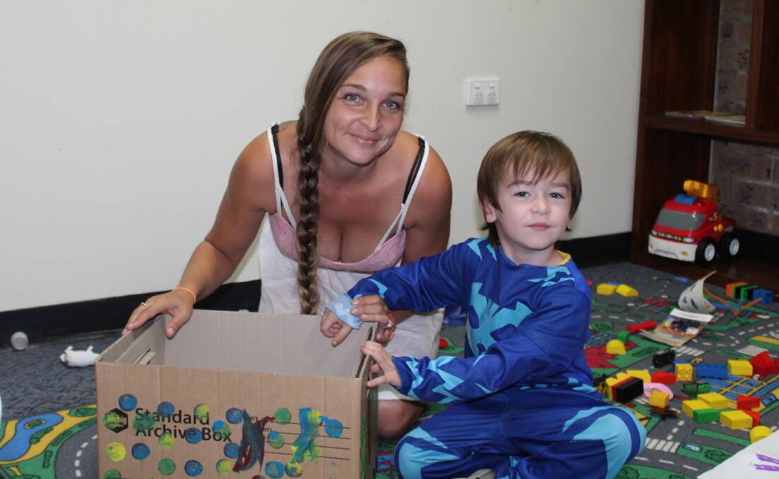 Tamara Blunn and Cohen playing with their HIPPY activity box.