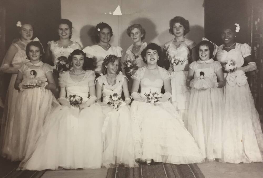 At one of the first debutante balls in Katherine, just nine girls partnered up and were presented with two young flower girls (also pictured). Picture: Supplied. 