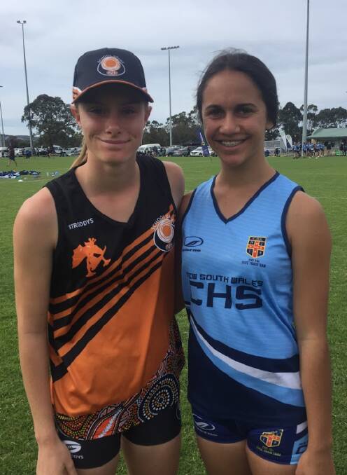 Under 15 Girls vice-captain Brianna Simmonds with her opposition number from NSW. Picture: Glenn Hayles. 