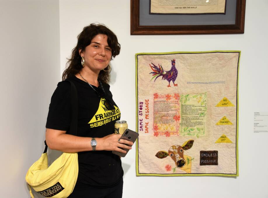 Carmen Ansaldo stands with her favourite artwork. 