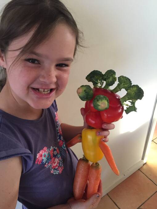 Sophie Moore with her veggie sculpture. Picture: Rebecca Moore.