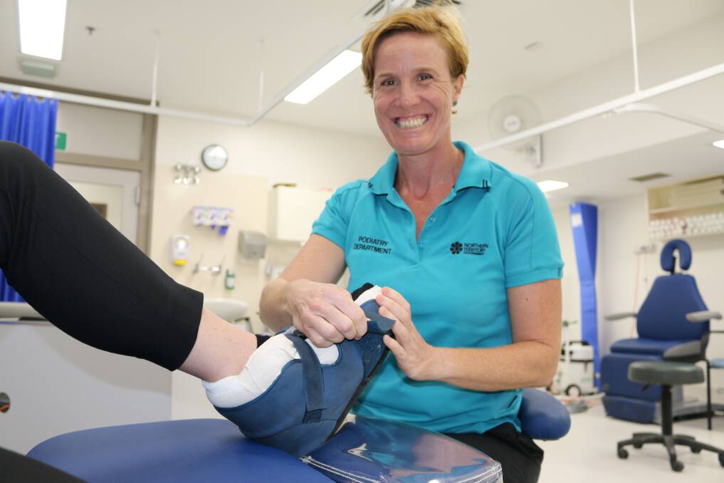 RDH podiatrist Sally Lamond applies a scotch cast boot to a patients foot.