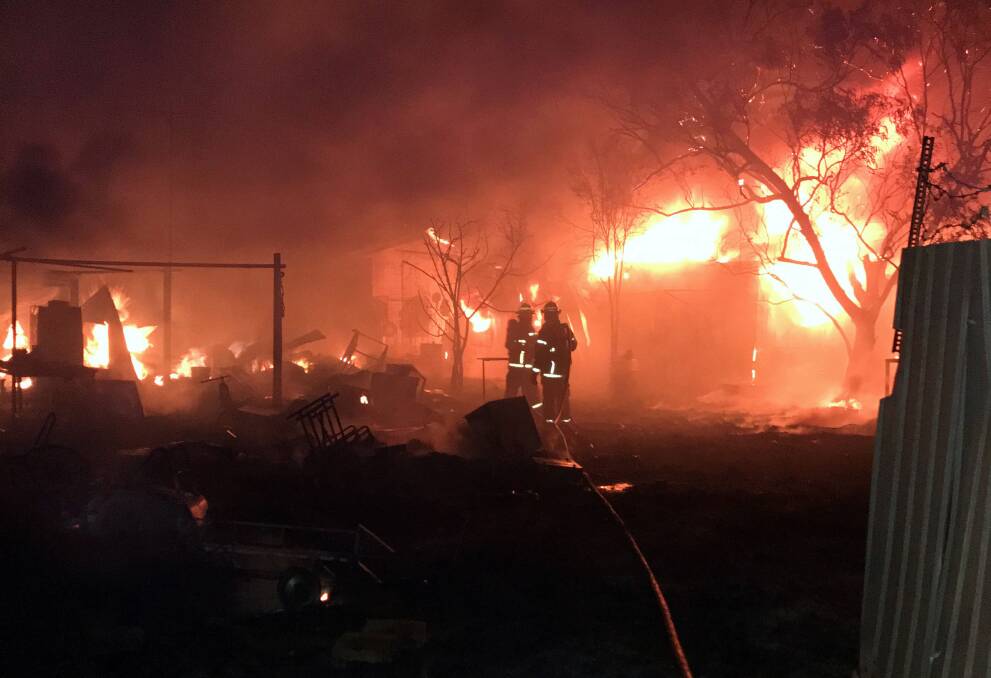 The blaze destroyed a home, three sheds, four caravans and three cars. Picture: NT Police.