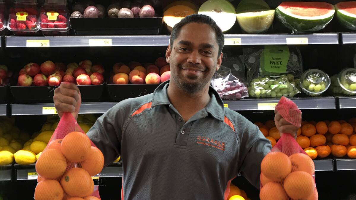HEALTHY CHOICES: Glen Wurramara from the Nguru Walalja store in Yuendumu stocking up fresh produce for the community. Picture: supplied.