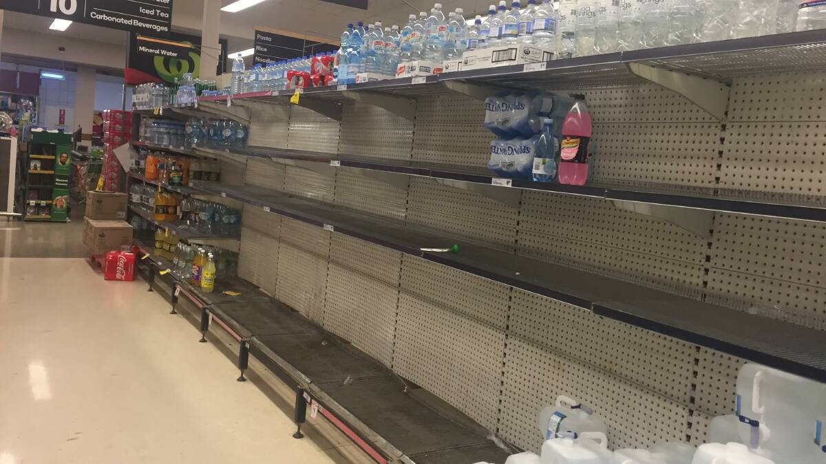 RESIDENTS TAKE ACTION: Katherine supermarket shelves stripped of bottled water. Picture: Lydia Lynch.