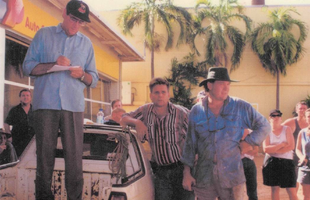 PUBLIC MEETING: Mike Reed (left), Tim Baldwin and Trevor Ford hold a town meeting from the back of a ute shortly after flood waters receded in 1998. Picture: Toni Tapp-Coutts.