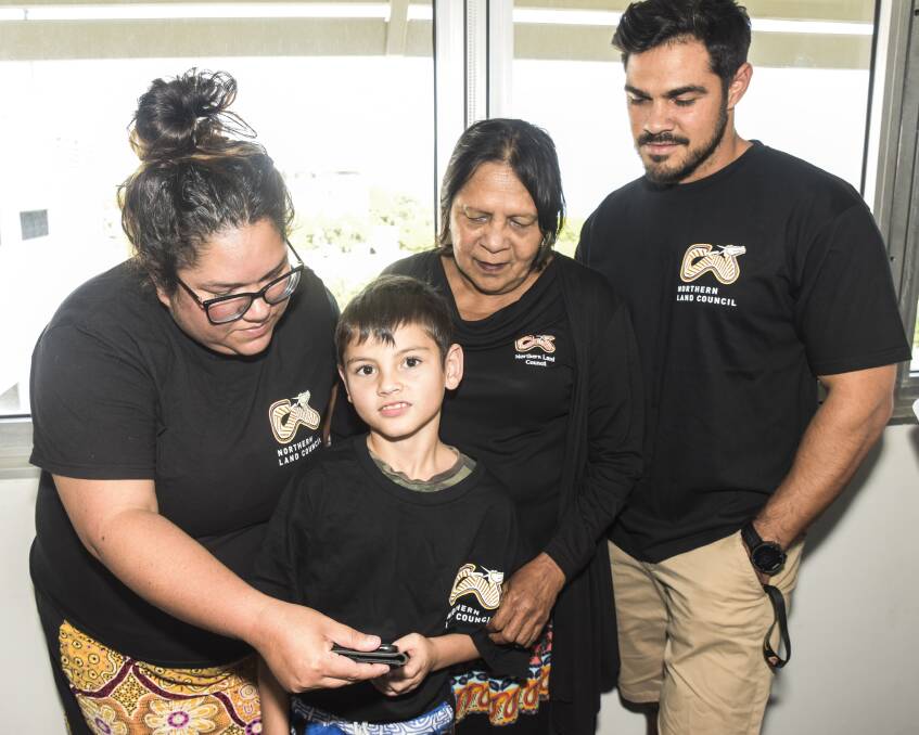 Nicole Brown, Joy Cardona and Jamie Damaso show young Josh the new app. Picture: supplied.