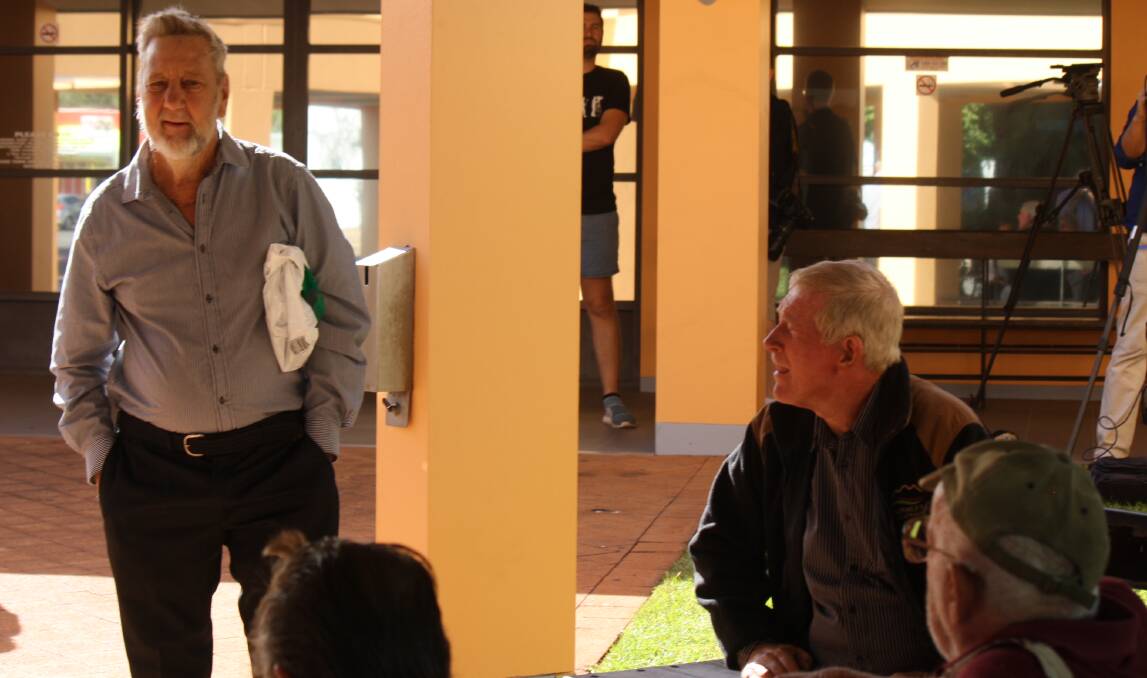 Publican Barry Sharpe (left) outside the Katherine Courthouse with other Larrimah residents during the June inquest.