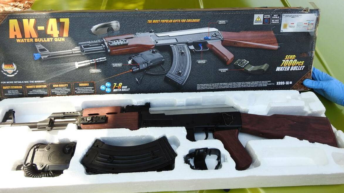 Kid's toy or imitation firearm, a replica machine gun police claim they found during a raid on a Katherine home late last year. Pictures: NT Police.