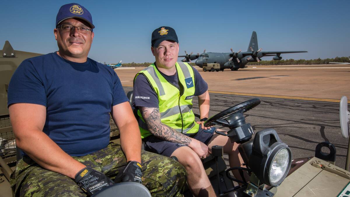 Corporal Shaun Ennis, of the Royal Canadian Air Force, and Leading Aircraftman Adam Commegno, from the Royal Australian Air Force, in front of a Canadian CC-130H(T) Hercules Refueller on the flightline of RAAF Tindal during Exercise Pitch Black 2018. Pictures: Defence Media.