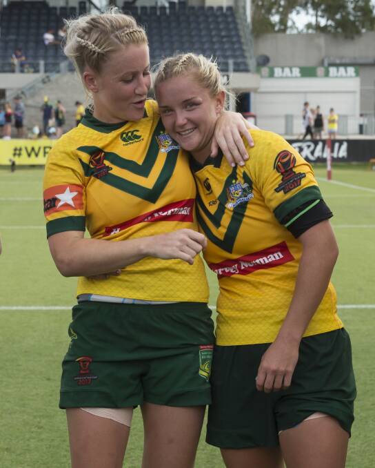 CELEBRATE: Annette Brander (left) and Meg Ward of Australia hug after the Women's Rugby League World Cup semi final between Australia and Canada on Sunday. Picture: Craig Golding/AAP.