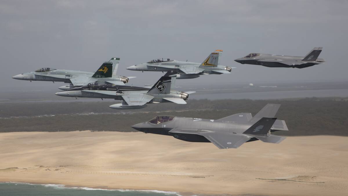 RAAF F/A-18 Hornets fly in formation with a pair of F-35A Joint Strike Fighters in 2018 over Stockton Beach in NSW. Picture: Defence Media.