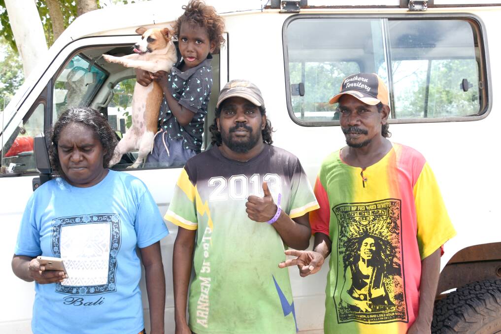 AFRAID: Nelly Wilfred, Zephariah Hall, Shane Bidindal, Timothy Hall and their dog Tristey Girl, looking after their brother's car at the temporary evacuation site in Katherine, have never experienced a cyclone like Trevor before. 