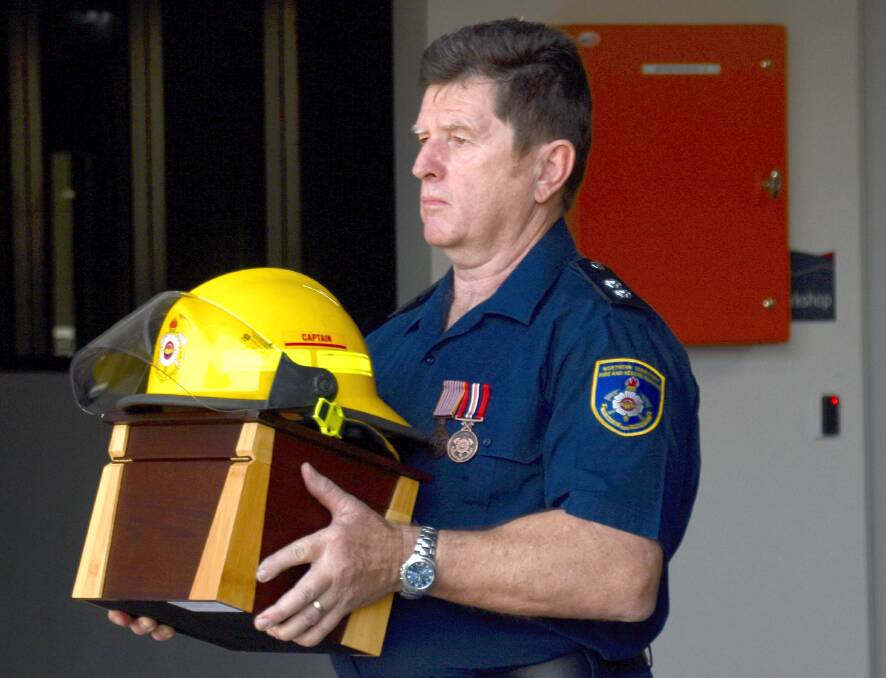 LAST TURNOUT: To conclude the last 'turnout' Katherine Fire Station officer Bernie Welsford carried Mr Stubbs' ashes to be transported in a fire truck and scattered by the family. 