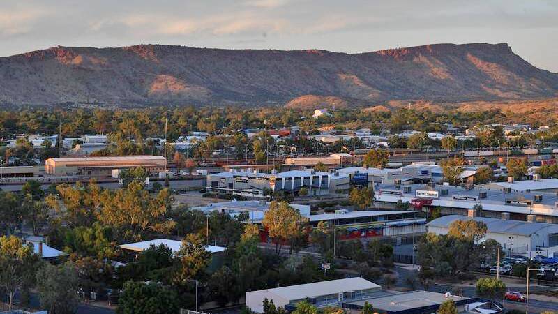 One of the new cases is in Alice Springs, after a woman returned from the Gold Coast.