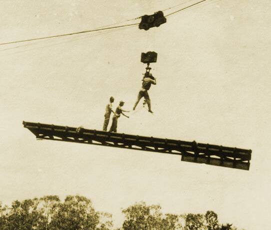 Don't try this at home - men working on the construction of the Katherine railway bridge using a dangerous looking flying fox in 1925. Picture: Katherine Historical Society.