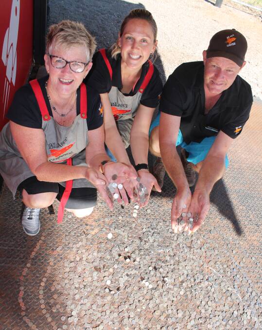 COINS FOR CANCER: Ree Dunn, Chrissy McKie and Mick Armstrong at the Pop Rocket Cafe in Katherine today.
