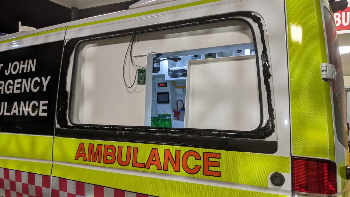 The back window of the ambulance was smashed while paramedics were working on a patient in Katherine on Saturday evening. Picture: supplied.