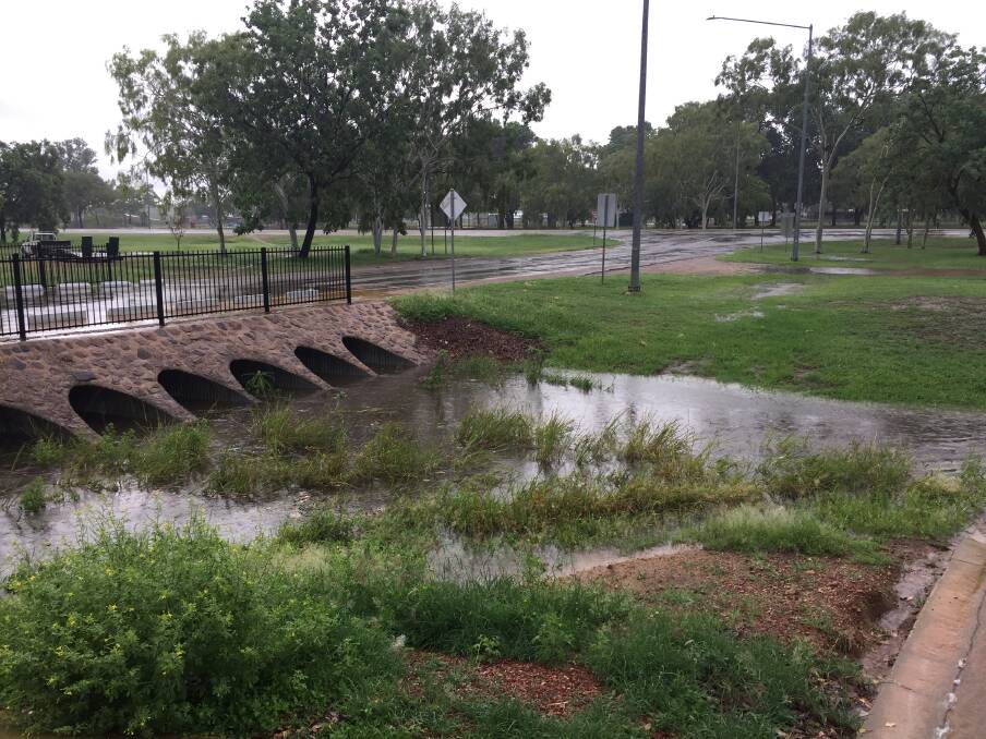 Gutters and drains overflowed during this morning's downpour. Pictures: Roxanne Fitzgerald.