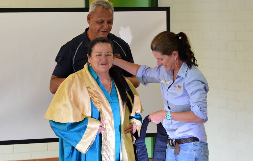 NEW LEADERSHIP: Roper Gulf Regional Council Chief Executive Officer Michael Berto and Manager Governance and Corporate Planning Amanda Haigh help newly-elected Mayor Judy MacFarlane with her robes after she was appointed to the role on September 14. Picture: Roper Gulf.