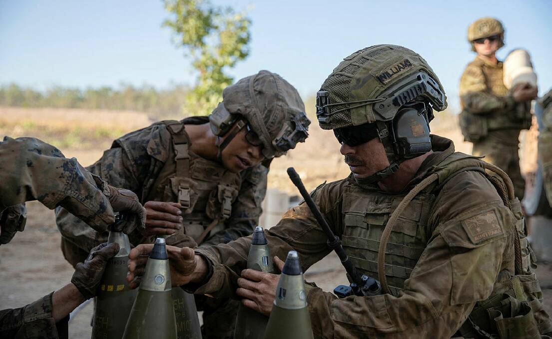 Bombardier Damian Williams (right), from 8th/12th Regiment, Royal Australian Artillery, and United States Marine Corps Lance Corporal Kevin Dominic Matias inspect the fuses of high explosive artillery projectiles during Exercise Koolendong held at Mount Bundey. Picture: Defence Media.